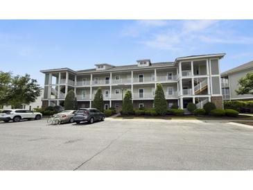 Inviting condo complex featuring multiple levels and exterior walkways and well-maintained landscaping at 224 Castle Dr. # 1408, Myrtle Beach, SC 29579