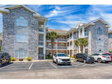 Beautiful condo complex featuring stone accents, covered balconies, and ample parking at 4741 Wild Iris Dr. # 303, Myrtle Beach, SC 29577