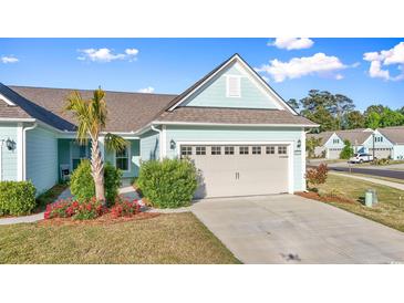 Charming single-story home with a two-car garage, well-maintained lawn, and a blue exterior paint scheme at 5876 Cremona Dr., Myrtle Beach, SC 29577