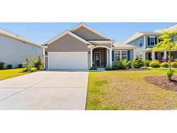 Charming single-story home featuring a well-manicured lawn and a two-car attached garage at 8077 Fort Hill Way, Myrtle Beach, SC 29579