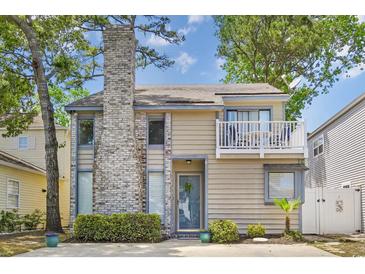 Charming home with a brick chimney and a cozy second-story balcony, great curb appeal at 829 9Th Ave. S, North Myrtle Beach, SC 29582