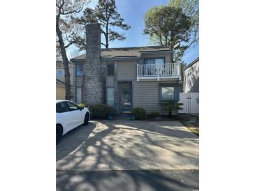Charming two-story home with a brick chimney and a cozy second-floor balcony at 829 9Th Ave. S, North Myrtle Beach, SC 29582