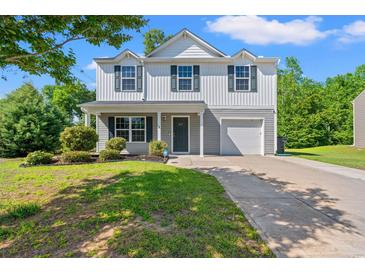 Charming two-story home with landscaped front yard, driveway, and attached one-car garage at 101 Winding Path Dr., Loris, SC 29569