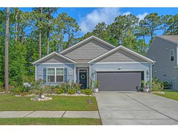 Charming single-Gathering home with a manicured lawn and a two-car garage at 1011 Maxwell Dr., Little River, SC 29566