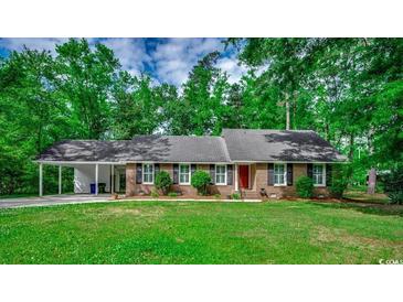Charming brick ranch home with a well-manicured lawn and mature trees at 107 Azalea Dr., Conway, SC 29526