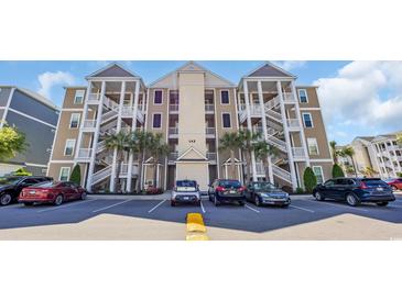 Beautiful condominium complex showcasing palm trees and ample parking spaces at 142 Ella Kinley Circle # 402, Myrtle Beach, SC 29588