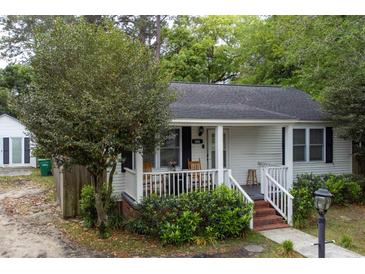 Charming single-story home with a welcoming front porch, well-maintained landscaping, and brick-lined entryway at 1521 Front St., Georgetown, SC 29440