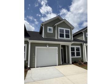 Two-story home featuring a single-car garage, gray siding, and manicured landscaping at 2076 Victory Way # 570, Myrtle Beach, SC 29579