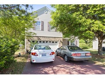 Charming two-story home with vinyl siding, brick accents, two-car garage, and well-maintained landscaping at 2170 Buxton Dr., Myrtle Beach, SC 29579