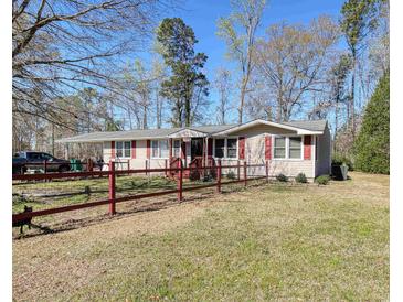 Charming ranch home with a red-picket fence and spacious front yard at 2917 Chippenham Rd., Marion, SC 29571