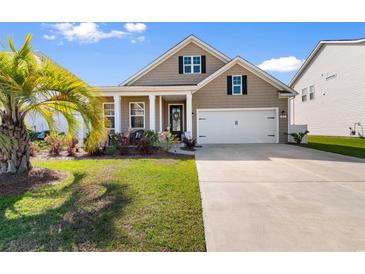 Charming single-Gathering home featuring a well-manicured lawn and an attached two-car garage at 315 Cattle Drive Circle, Myrtle Beach, SC 29588