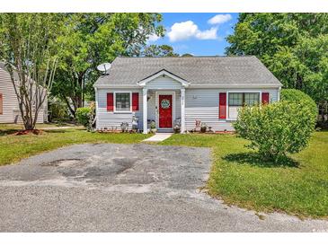 Charming single-story home with red door, red shutters, and small front yard at 6628 Mallard View Point, Myrtle Beach, SC 29588