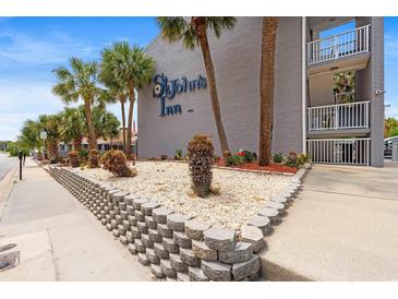 St. John's Inn exterior view showcasing the well-maintained landscaping and inviting entrance at 6803 N Ocean Blvd. # 328, Myrtle Beach, SC 29572