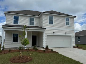 Charming two-story home with a manicured lawn and a two-car garage, offering classic curb appeal at 1038 Laconic Dr., Myrtle Beach, SC 29588