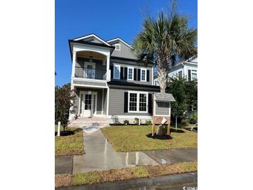 Charming two-story home with gray siding, white trim, and a small front yard at 1348 Rue De Jean Ave., Myrtle Beach, SC 29579