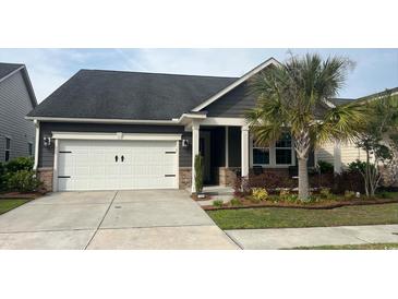 Charming single-story home featuring a two-car garage and beautifully landscaped front yard with a palm tree at 1488 Culbertson Ave., Myrtle Beach, SC 29577