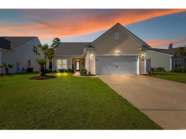 Charming single Gathering home featuring a well maintained lawn, an attached two car garage, and a welcoming front entrance at 2446 Craven Dr., Myrtle Beach, SC 29572