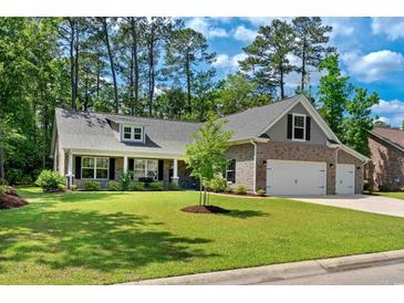 Charming single-Gathering home with brick accents, well-manicured lawn, and two-car garage at 370 Foxtail Dr., Longs, SC 29568