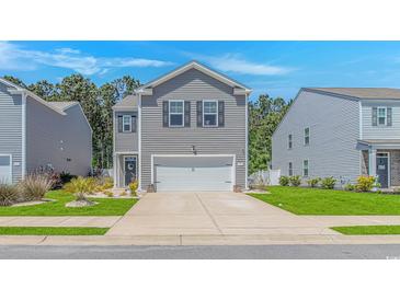 Charming gray two-story home featuring a two-car garage, landscaped front yard, and welcoming curb appeal at 396 Emery Oak Dr., Murrells Inlet, SC 29576