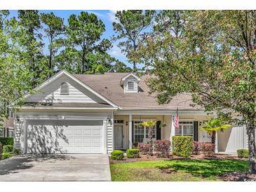 Charming single-story home featuring a manicured lawn, attached garage, and inviting curb appeal at 442 Mahogany Dr. # 101, Murrells Inlet, SC 29576