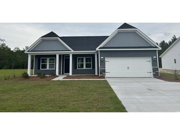 Charming single-Gathering home features a two-car garage, manicured lawn, and classic architectural details at 4762 Huckleberry Ln., Conway, SC 29526