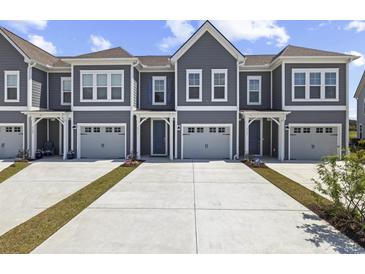 Inviting townhome with gray siding, white trim, and attached one car garage at 5111 Double Eagle Way # 3, North Myrtle Beach, SC 29582