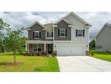 Charming two-story home with stone accents, a two-car garage, and well-manicured landscaping at 7039 Shooting Star Way, Myrtle Beach, SC 29579