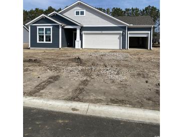 Charming single-story home with blue siding, white trim, two-car garage, and lovely architectural details at 905 Inlet Keys St., Murrells Inlet, SC 29576