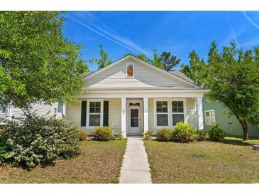 Charming single-story home with a well-manicured lawn, sidewalk, and inviting front porch at 908 Oglethorpe Dr., Conway, SC 29527