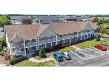An inviting exterior of a two-story condo with charming balconies and well-maintained landscaping at 138 Butkus Dr. # 2, Myrtle Beach, SC 29588