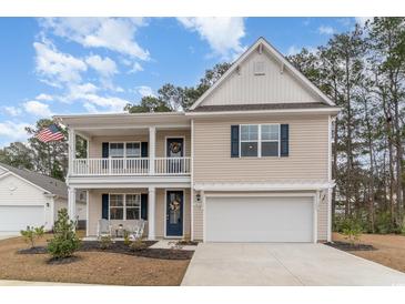 Charming two-story home with a welcoming front porch and attached two-car garage at 141 Ranch Haven Dr., Murrells Inlet, SC 29576
