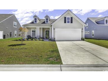 Charming single-Gathering home with a two-car garage, manicured lawn, and inviting front porch at 1463 Villena Dr., Myrtle Beach, SC 29579
