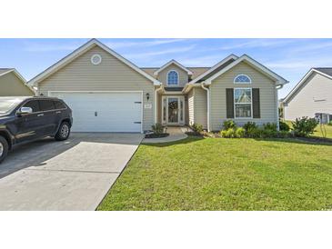 Charming single-story home featuring a well-manicured lawn and attached two-car garage at 313 Palladium Dr., Surfside Beach, SC 29575