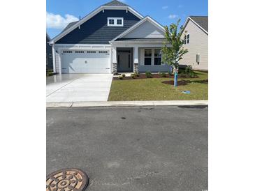 Charming single-story home featuring a two-car garage, manicured lawn, and inviting front entrance at 363 Broughton Dr., Myrtle Beach, SC 29579