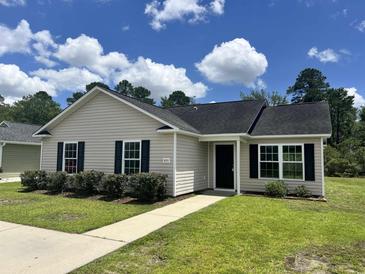 Charming single-story home with manicured lawn, black shutters, and a paved walkway at 469 Overcrest St., Myrtle Beach, SC 29579