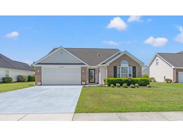 Charming single-story home featuring a well-manicured lawn and a two-car garage at 5107 Capulet Circle, Myrtle Beach, SC 29588