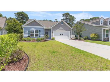 Charming single-story home with a well-manicured lawn and a two-car garage, perfect for suburban living at 5581 Plantersville Pl., Myrtle Beach, SC 29579