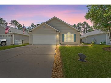 Charming single-story home featuring a well-manicured lawn and a two-car garage on a peaceful street at 6485 Royal Pine Dr., Myrtle Beach, SC 29588