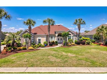 Charming single-story home featuring well-manicured lawn, mature landscaping, and inviting curb appeal at 8050 Wacobee Dr., Myrtle Beach, SC 29579