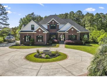 Beautiful brick two-story home featuring a circular driveway, manicured lawn, and boat parking at 9449 Freewoods Rd., Myrtle Beach, SC 29588