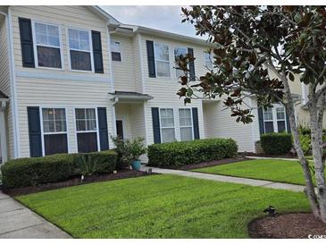 Inviting townhome with well-manicured lawn and lush landscaping, offering great curb appeal at 109 Old Town Way # 4, Myrtle Beach, SC 29588