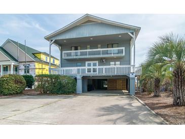 Charming coastal home featuring multi-level balconies and covered parking at 1184 Parker Dr., Pawleys Island, SC 29585