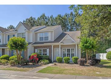 Charming townhome exterior with well-maintained landscaping, lovely flowers, and welcoming curb appeal at 1249 Shoebridge Dr. # 1249, Myrtle Beach, SC 29579