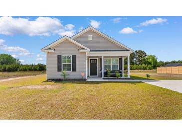 Charming single-story home with gray siding, black shutters, and a cozy front porch at 1396 Highway 129, Galivants Ferry, SC 29544