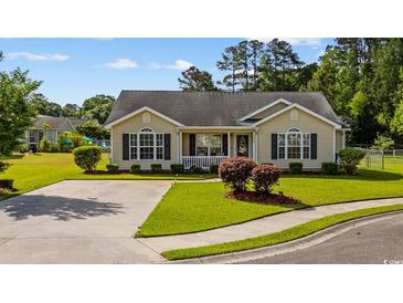 Charming single-story home with manicured lawn, inviting curb appeal, and neutral-colored siding at 1505 Bramber Pl., Conway, SC 29527