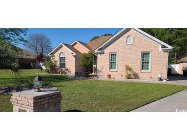 Charming brick home with a well-manicured lawn, showcasing its curb appeal and inviting exterior at 1717 Perdiz Covey Ct., Myrtle Beach, SC 29588