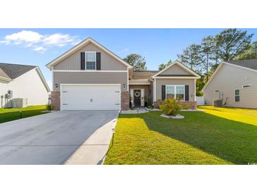 Charming home featuring a two-car garage, beautiful lawn, and classic curb appeal on a sunny day at 263 Lakota Loop, Longs, SC 29568