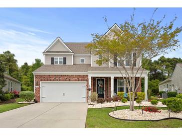 Charming two-story home with a brick facade, landscaped yard, and a two-car garage at 4246 Livorn Loop, Myrtle Beach, SC 29579