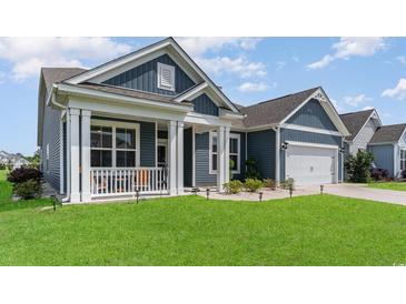 Charming home with a covered front porch and manicured lawn at 567 Hickman St., Surfside Beach, SC 29575