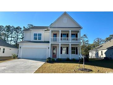 Charming two-story home with a covered porch and manicured lawn on a sunny day at 631 Fair Feather Ct., Myrtle Beach, SC 29588